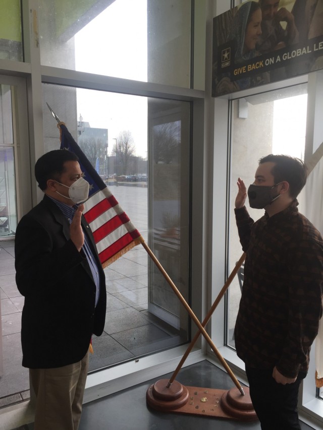 Retired Col. John Diaz gives the oath of enlistment to his son, Cameron Diaz, when he enlists in the Army Feb. 22, 2021. (Photo by Sgt. 1st Class Christopher Owens, Wiesbaden Recruiting Station)