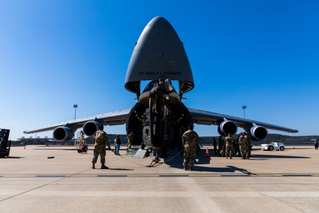 Soldiers and Airmen from 3rd Battalion, 227th Aviation Regiment, 1st Air Cavalry Brigade, 1st Cavalry Division and 621st Mobility Support Operations Squadron make minor adjustments to move the UH-60 Black Hawk into the Lockheed C-5 Galaxy aircraft...