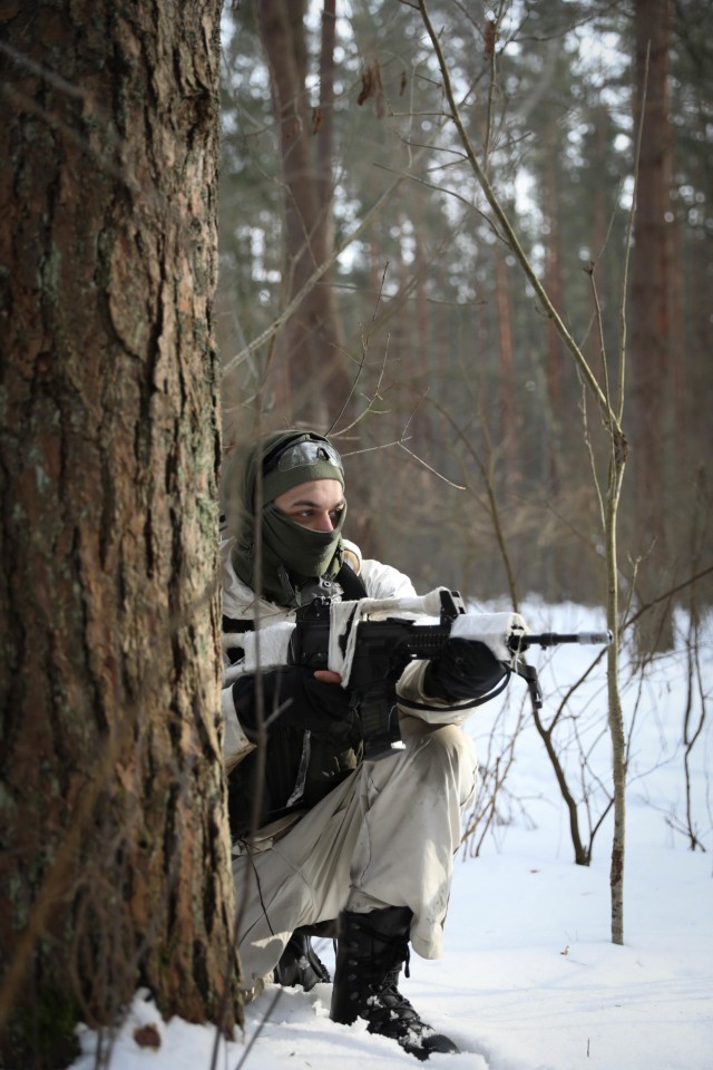 A Lithuanian Volunteer Force soldier provides perimeter security as his fellow team members set up an ambush Feb. 21, 2021, at the Kairai Training Area, Lithuania. Lithuanian 21st Dragoon Battalion and U.S. 2nd Battalion, 8th Cavalry Regiment conducted a combined training event to test the abilities of Lithuanian forces to halt or stop heavy weaponry 2-8 Cav. Reg. employs on the battlefield. (U.S. Army photo by Sgt. Alexandra Shea)