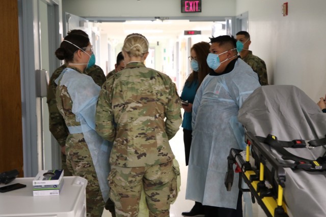 Emergency Medical Technicians and staff prepare to move an actor posing as a COVID-19 patient during a patient transfer exercise on Jan. 31, 2021 at the main campus William Beaumont Army Medical Center.  The exercise simulated patients’ movement from the legacy facility (current hospital) to the replacement hospital in preparation for the upcoming move on March 28.
