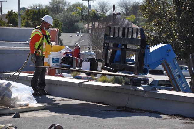 Workers for the U.S. Army Corps of Engineers project at Beverly Hospital, Montebello, California,  bring constructions materials to the roof, Feb. 23, 2021.