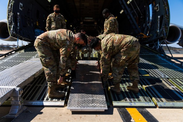 Soldiers and Airmen from 3rd Battalion, 227th Aviation Regiment, 1st Air Cavalry Brigade, 1st Cavalry Division and 621st Mobility Support Operations Squadron worked together to set up the ramp to move the UH-60 Black Hawk into the Lockheed C-5...