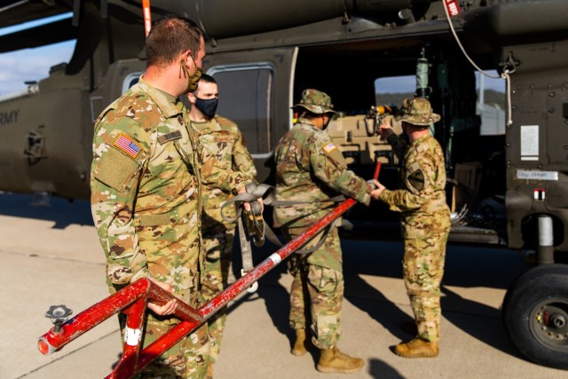 U.S. Army Soldiers and Airmen from 3rd Battalion, 227th Aviation Regiment, 1st Air Cavalry Brigade, 1st Cavalry Division and 621st Mobility Support Operations Squadron, load equipment onto a UH-60 Black Hawk before transportation at Fort Hood,...