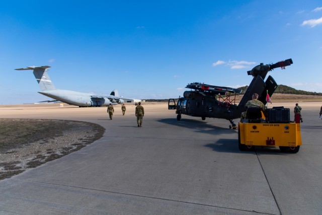 Sgt. Bryan Battaglia, a Maintenance Supervisor from 3rd Battalion, 227th Aviation Regiment, 1st Air Cavalry Brigade, 1st Cavalry Division, helps to move the UH-60 Black Hawk to the Lockheed C-5 Galaxy aircraft at Fort Hood, Texas, February 24,...
