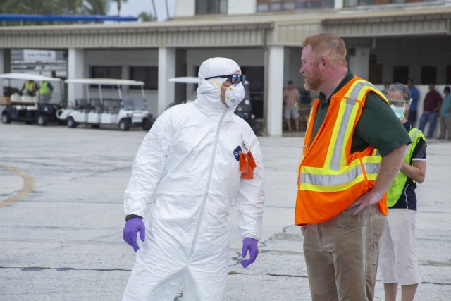 Joseph Dacanay, Vector Control manager, talks with Scott Masingill, LOGCAP Quality, Environment, Safety and Health manager. (U.S. Army photo by Jessica Dambruch)