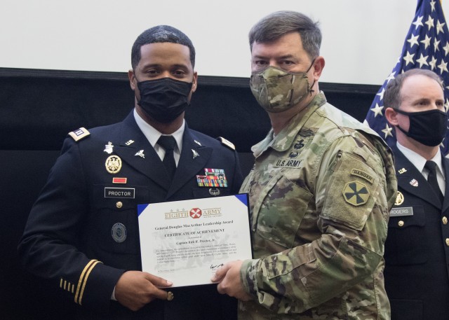 Capt. Kirk Proctor (left) receives a certificate of achievement from Lt. Gen. Bill Burleson, Eighth Army commanding general, during a ceremony held at Eighth Army headquarters on Camp Humphreys, South Korea, Nov. 23. Proctor was selected as one of the Eighth Army nominees for the General Douglas MacArthur Leadership Award.