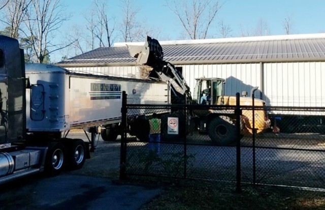 A bucket loader dumps brass into a trailer bed so it can be hauled away for recycling. The program is part of the Qualified Recycling Program here. It is managed by the Directorate of Public Works Environmental Management Division with support...
