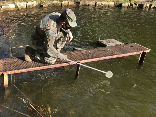 Staff Sgt. Matthew Pascual, noncommissioned officer in charge of entomology for Public Health Command-Pacific in Japan, samples for mosquito larvae during a vector surveillance survey on Camp Zama, Japan, Feb. 25, 2021. Collecting vector samples allows for PHC-P scientists to analyze areas of interest for potential vector-borne diseases that could impact the health of the force. (Courtesy photo)