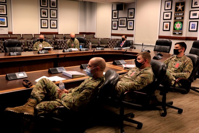 U.S. Army officers from the 1st Security Force Assistance Brigade meet at U.S. Army South headquarters for the Operation Alamo Shield pre-deployment training conference on Joint Base San Antonio Fort Sam Houston, Texas, Feb. 25, 2021. The Operation Alamo Shield pre-deployment training conference, hosted by U.S. Army South, serves to prepare members of the 1st Security Force Assistance Brigade for future missions in Colombia, Honduras and Panama. The 1st SFAB, working alongside their Colombian, Honduran and Panamanian counterparts, strengthens existing regional partnerships and fosters a deeper professional and shared understanding of challenges faced in the Western Hemisphere. (U.S. Army photo by Pfc. Joshua Taeckens) (This photo was edited from its original version)