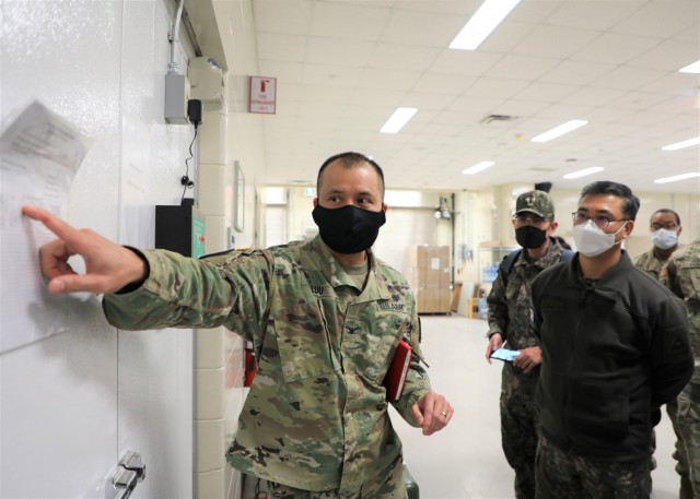 549th HC/BDAACH commander, Col. Huy Luu, is explaining how the organization the process of storing the vaccine to ROK Brig. Gen. Beom Man Ha, ROK Army Surgeon General and the ROK Armed Forces Medical Command team during a tour of the hospital’s COVID-19 vaccine operations, and visited the COVID-19 Vaccination Center on Feb. 18, 2021.