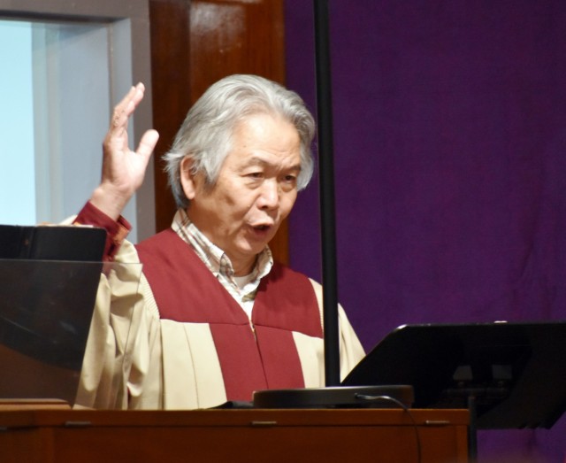 Shunji Sakita, director of the choir for the Holy Family Catholic Community, sings and directs the choir at the Camp Zama Chapel, Camp Zama, Japan, Feb. 17.