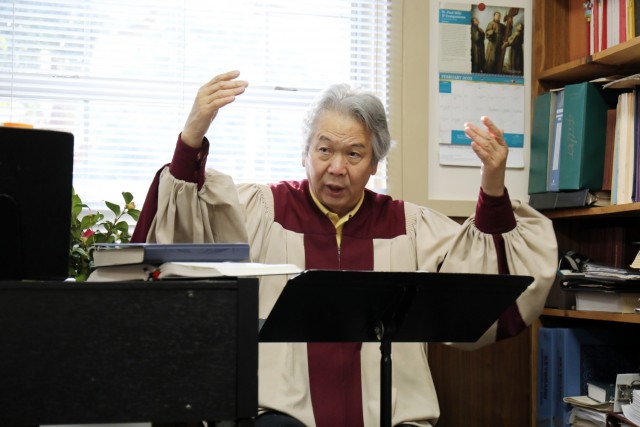 Shunji Sakita, director of the choir for the Holy Family Catholic Community, practices with the choir at the Camp Zama Chapel, Camp Zama, Japan, Feb. 21.
