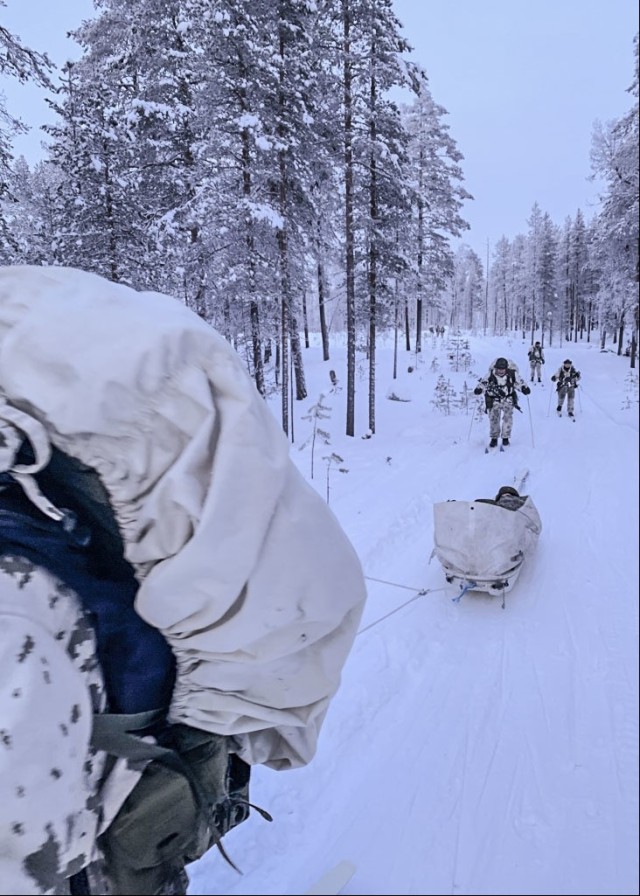 ROVANIEMI, Finland – Students pull a simulated casualty while cross country skiing during the Winter Combat Course near Rovaniemi, Finland, located just four miles south of the Arctic Circle, Jan. 17. With temperatures reaching as low as -37 degrees Celsius and a landscape covered with a meter of snow, two U.S. Soldiers assigned to U.S. Army Health Clinic Kaiserslautern joined the two-week long exercise, familiarizing themselves with topics such as using layered clothing, protecting against and treatment of injuries relating to frostbite, sustaining performance capability, making fire by using ad hoc tools, getting versatile skiing practice (including cross-country skiing downhill and uphill, skiing skills track, and skiing with and without a rucksack) and marksmanship practice with and without night vision equipment also on skis, utilizing snow vehicles, fortifying in snow, and conducting combat operations in snowy conditions.