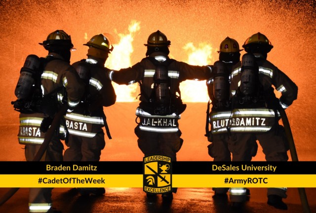 Cadet Damitz, along with fellow firefighters, work to extinguish a fire.