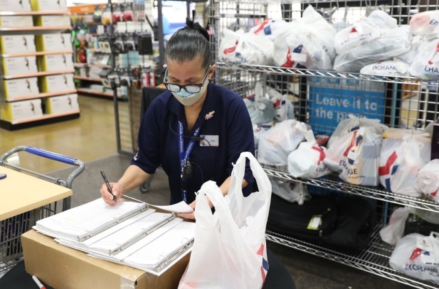 AAFES Main Exchange associate Susan Morales logs items before they are loaded and delivered to quarantined military personnel at Fort Bliss, Texas, Feb. 25, 2021.