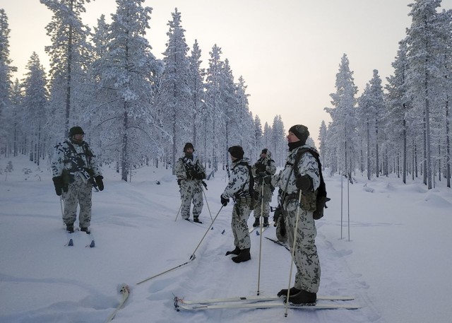 ROVANIEMI, Finland – Students engage in cross country skiing during the Winter Combat Course near Rovaniemi, Finland, located just four miles south of the Arctic Circle, Jan. 20. With temperatures reaching as low as -37 degrees Celsius and a landscape covered with a meter of snow, two U.S. Soldiers assigned to U.S. Army Health Clinic Kaiserslautern joined the two-week long exercise, familiarizing themselves with topics such as using layered clothing, protecting against and treatment of injuries relating to frostbite, sustaining performance capability, making fire by using ad hoc tools, getting versatile skiing practice (including cross-country skiing downhill and uphill, skiing skills track, and skiing with and without a rucksack) and marksmanship practice with and without night vision equipment also on skis, utilizing snow vehicles, fortifying in snow, and conducting combat operations in snowy conditions.