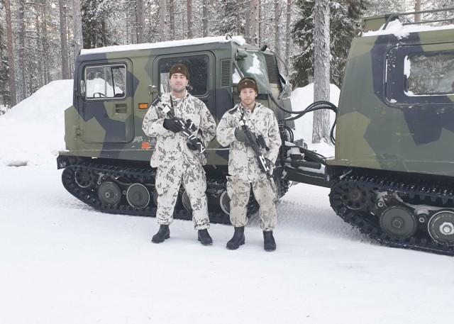 ROVANIEMI, Finland – (From left) U.S. Army Capt. Samuel Pankonen, the chief nursing officer at Kaiserslautern Army Health Clinic, and U.S. Army Staff Sgt. Elias Bonilla, laboratory technician at Kaiserslautern Army Health Clinic, participate in the Winter Combat Course near Rovaniemi, Finland, located just four miles south of the Arctic Circle, Jan. 17. With temperatures reaching as low as -37 degrees Celsius and a landscape covered with a meter of snow, Pankonen and Bonilla joined a multinational cohort for the two-week long exercise, familiarizing themselves with topics such as using layered clothing, protecting against and treatment of injuries relating to frostbite, sustaining performance capability, making fire by using ad hoc tools, getting versatile skiing practice (including cross-country skiing downhill and uphill, skiing skills track, and skiing with and without a rucksack) and marksmanship practice with and without night vision equipment also on skis, utilizing snow vehicles, fortifying in snow, and conducting combat operations in snowy conditions.