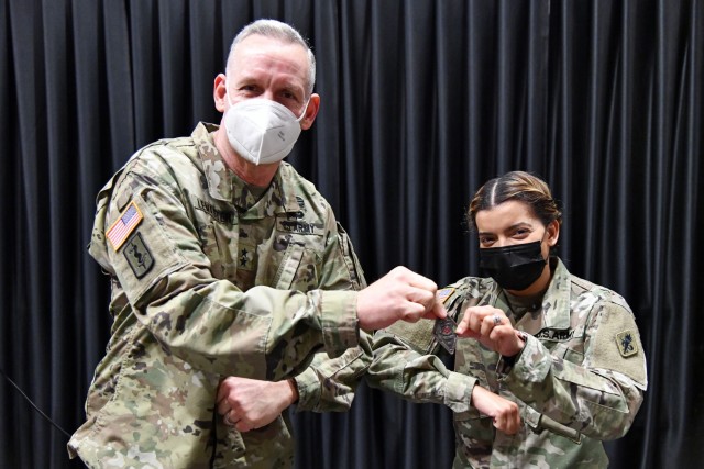 Maj. Gen. Dennis P. LeMaster, Commanding General MEDCoE, presents a commander’s coin to Capt. Amaya Vargas, Commander, Bravo Company, 188th Medical Battalion for organizing and moderating the Women’s History Month panel discussion.