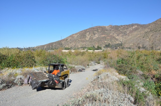 The U.S. Army Corps of Engineers Los Angeles District hauls debris left at a former homeless encampment, March 1, 2021.