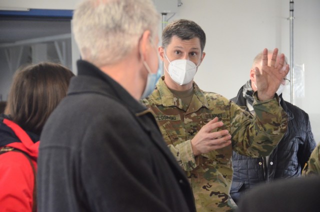 Col. Vance J. Klosinski explains garrison efforts to combat COVID to Matthias Schneider, Birkenfeld, Germany, County Commissioner (foreground), during a visit to Baumholder Military Community. The two-hour visit provided the commissioner and other local German officials insight into how the Army fights COVID and protects its population in the Baumholder community.