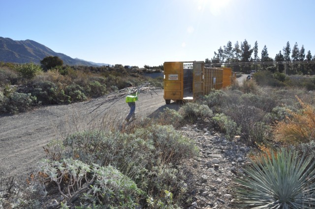 The U.S. Army Corps of Engineers Los Angeles District hauls debris left at a former homeless encampment, March 1, 2021.