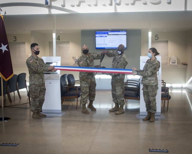 Brig. Gen. Shan Bagby, Brooke Army Medical Center Commanding General, and Col. Stacey Causey, BAMC pharmacy chief, cut a ribbon during a Facebook Live ceremony, signifying the grand opening of the Fort Sam Houston Community Pharmacy, Fort Sam Houston, Texas, March 3. The new pharmacy is about 1,600 square feet larger than the old location and is designed to allow a better overall operational flow and more workspace for the pharmacy team to safely work. (U.S. Army photo by Jason W. Edwards)
