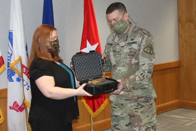 Julie Ferrigno (left), Accountable Officer for Tank-automotive and Armaments Command General Officer Pistol Program, issues a SIG Sauer Modular Handgun System to Brig. Gen. Glenn Dean, Program Executive Officer Ground Combat Systems (right) on...