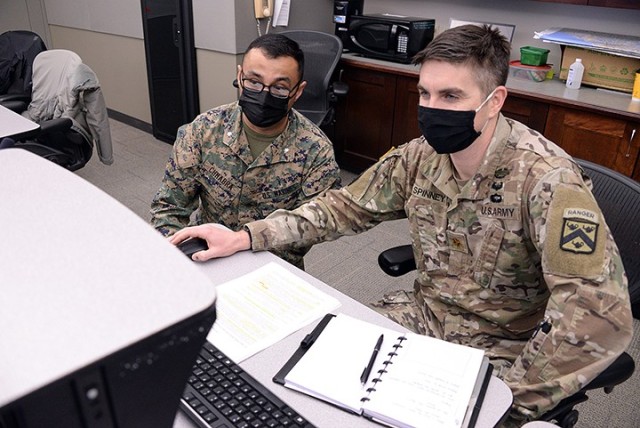 Marine Lt. Col. Tom Chhabra, assistant professor in the Department of Joint, Interagency and Multinational Operations, Command and General Staff College, observes Command and General Staff Officer Course students, including Maj. Gerard Spinney, as...