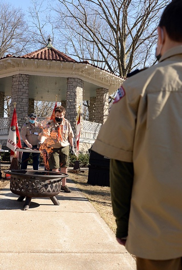 Thirteen-year-old Scout Sam Rowley, Troop 366 fire support, lights a Webelos neckerchief on fire, using a solution that would only make it appear to be on fire but not actually burn it, while Erick Sweet, Troop 366 assistant Scoutmaster and master...