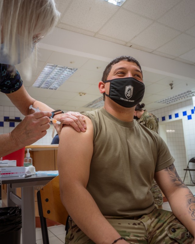 U.S. Army Spc. Scott Garcia, a UH-60 Blackhawk crew member with the 12th Combat Aviation Brigade, Wings of Victory, smiles for his second and final COVID vaccine dose on Feb. 24, 2021 in Wiesbaden, Germany. (U.S. Army photo by Maj. Robert Fellingham)