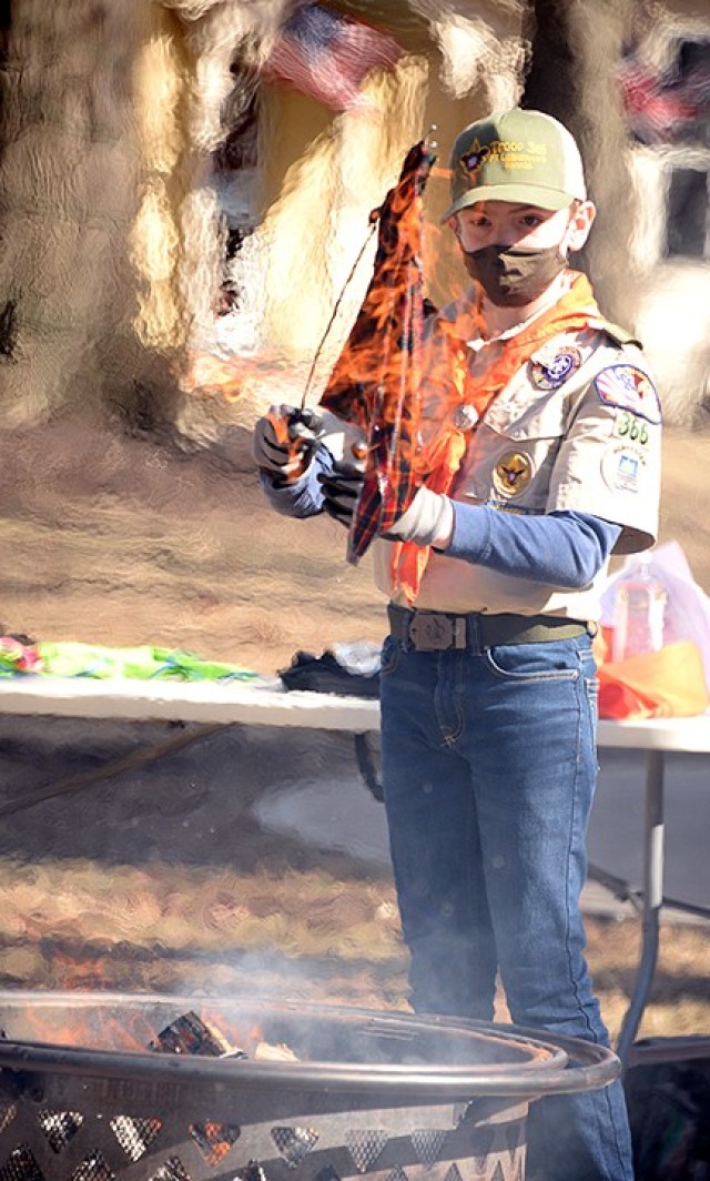 Twelve-year-old Scout Ben Sweet, Troop 366 fire support, lights a Webelos neckerchief on fire, using a solution that would only make it appear to be on fire but not actually burn it, during the Cub Scouts to Scouts BSA crossover ceremony Feb. 27...