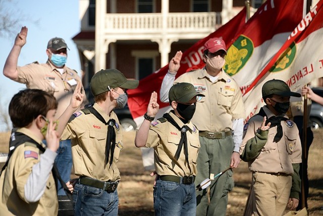 Erick Sweet, assistant Scoutmaster for Troop 366, and Ron Myers, assistant Scoutmaster for Troop 66, reaffirm the Scout Oath with Scouts Josh Myers, Dylan Brookshire, Ben Brookshire and Rohan Johnson during the boys' crossover ceremony from Cub...