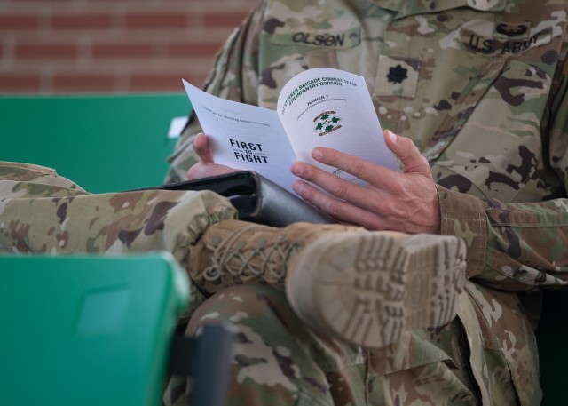 Lt. Col. Andrew Olson, commander, 299th Brigade Engineer Battalion, 1st Stryker Brigade Combat Team, 4th Infantry Division, reads the program for the 1st SBCT change of responsibility ceremony at Fort Carson, Colorado, September 23, 2020. The ceremony was smaller in scale in order to ensure proper COVID-19 precautions were taken. (U.S. Army photo by Capt. Daniel Parker)