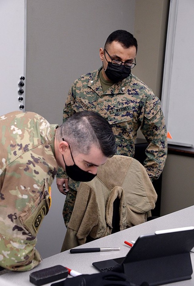 Marine Lt. Col. Tom Chhabra, assistant professor in the Department of Joint, Interagency and Multinational Operations, Command and General Staff College, observes Command and General Staff Officer Course students, including Maj. Aaron Phillips, as...