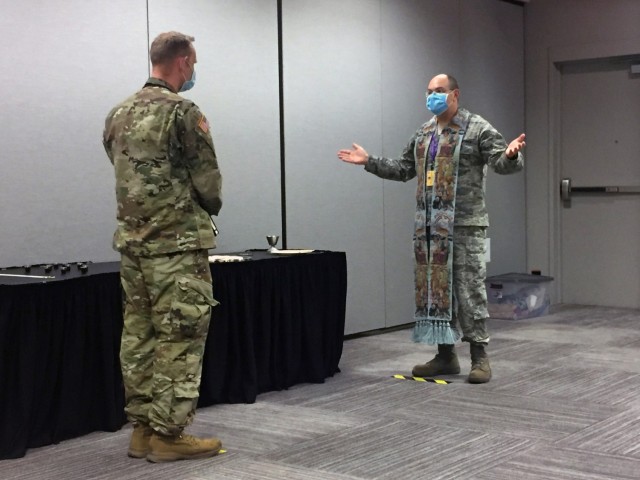 Air Force Chaplain (Lt. Col.) Jake Marvel, with the New York Air National Guard, gives Holy Communion to a U.S. Army Soldier at New York City’s Jacob K. Javits Convention Center, on Easter Sunday. Marvel has been mobilized to the alternate care facility as part of a Religious Support Team in response to COVID-19. (U.S. Air National Guard Photo by Staff Sgt. Nicholas Mancuso)