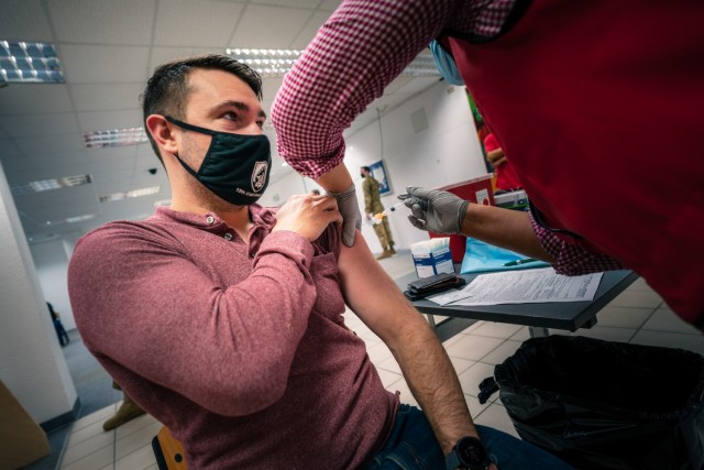 U.S. Army Capt. Josh Cox, a UH-60 Black Hawk pilot assigned to 1st Battalion, 214th Aviation Regiment, 12th Combat Aviation Brigade, reports in from leave for his second and final COVID vaccine dose on Feb. 24, 2021, in Wiesbaden, Germany. (U.S....