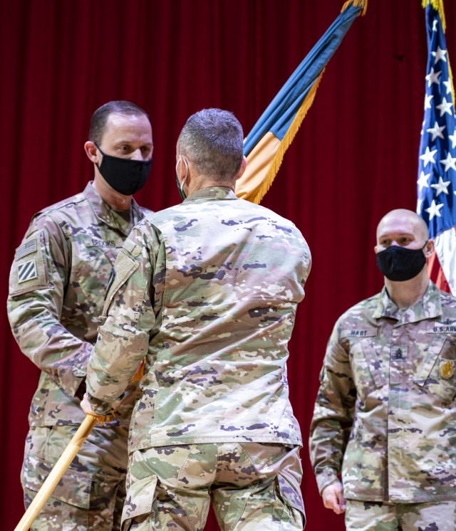 Lt. Gen. Daniel L. Karbler, Commander, U.S. Army Space and Missile Defense Command, passes the 1st Space Brigade guidon to incoming brigade commander Col. Donald K. Brooks during an assumption of command ceremony held at Fort Carson, CO March 5th, 2021.