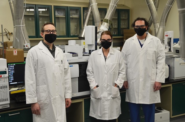 Chemists (pictured from left) Jeremy Jex, Hannah Line and Travis Losser with the Chemical Test Division’s Chemical Analytical Branch stand in front of a GC-QQQ, a highly sensitive instrument that they proved can be used to analyze chemical warfare agents. Their supervisor, Dr. Richard Phan (not pictured), provided support during the process and fellow colleagues Judy Fox, Rebecca Mine and Alexander Grimaldi contributed to the project. The group will present their findings during a virtual technical conference in early March. 