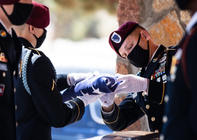 Paratroopers assigned to D Company, 2nd Battalion, 325th Airborne Infantry Regiment, 2nd Brigade Combat Team, 82nd Airborne Division, fold the U.S. Flag during a funeral service for Pfc. Harvey Brown, a World War II veteran formerly assigned to...