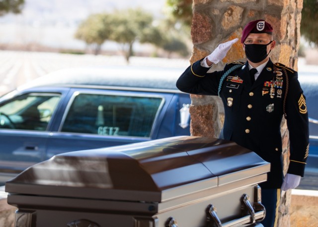 Sgt. 1st Class Michael Stroud, a platoon sergeant assigned to D Company, 2nd Battalion, 325th Airborne Infantry Regiment, 2nd Brigade Combat Team, 82nd Airborne Division salutes the casket of Pfc. Harvey Brown, a World War II veteran formerly...