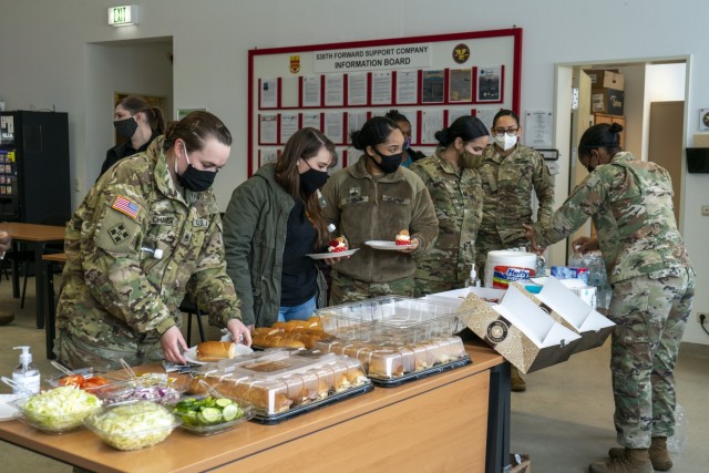 Female Soldiers assigned to the 41st Field Artillery Brigade grab some food during their Sisters in Arms luncheon held on Grafenwoehr, Germany Feb. 11, 2021. Sisters in Arms is an unofficial, grass roots movement that allows Female Soldiers to network with one another. (Official photo by Spc. Ryan Barnes)