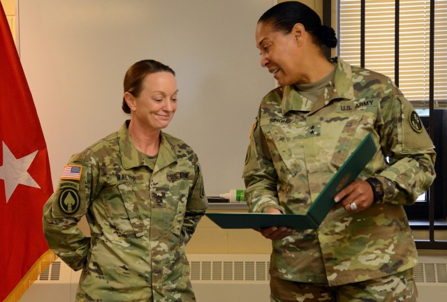 Maj. Gen. Linda L. Singh, right, the adjutant general of Maryland, presents a certificate of achievement to Staff Sgt. Rachel Walter, a supply sergeant assigned to the Maryland National Guard, at the Ruhl Armory in Towson, Md., June 5, 2016. Singh, who retired in 2019, was one of the inductees into the Army Women&#39;s Foundation&#39;s hall of fame during a virtual ceremony March 8, 2021. 