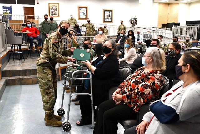 Col. Tiffany Chapman, Fort Polk staff judge advocate, presents Phyllis Lenz, paralegal specialist, with a civilian honorary award at the Office of the Staff Judge Advocate awards breakfast held March 3 at the Showboat Theater.