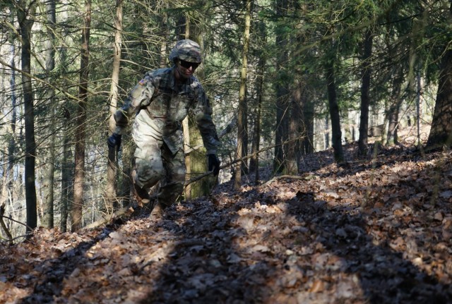 Pfc. Samuil Matveev, USAG Rheinland Pfalz, traverses up a hill during the Rough Terrain Course at Oberdachstetten Training Area March 1 as part of the Installation Management Command-Europe Best Warrior Competition running from Feb. 28 to Mar. 3.  The competition enhances expertise, training, and understanding of the skills needed to be a well-rounded Soldier. Winners will go on to compete at the Installation Management Command level in San Antonio, Texas.