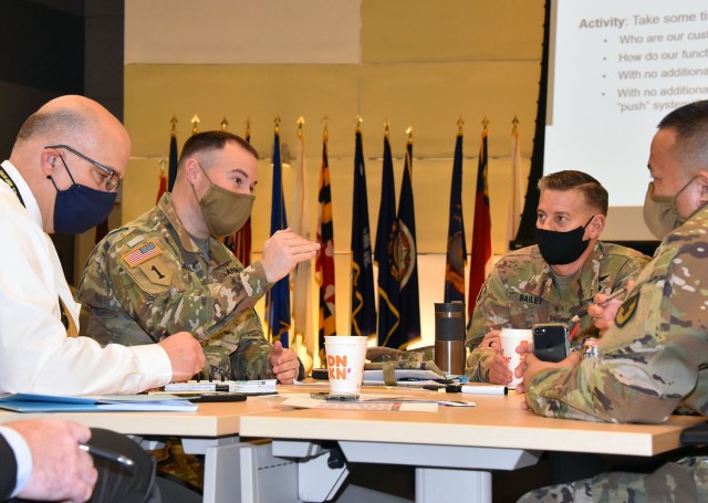 Lt. Col. Dan O'Neill, second from left, deputy commander of the U.S. Army Medical Materiel Agency, talks with USAMMA leaders during an Army Medical Logistics Command workshop on March 4 at Fort Detrick, Maryland. USAMMA is one of three direct reporting units to AMLC.
