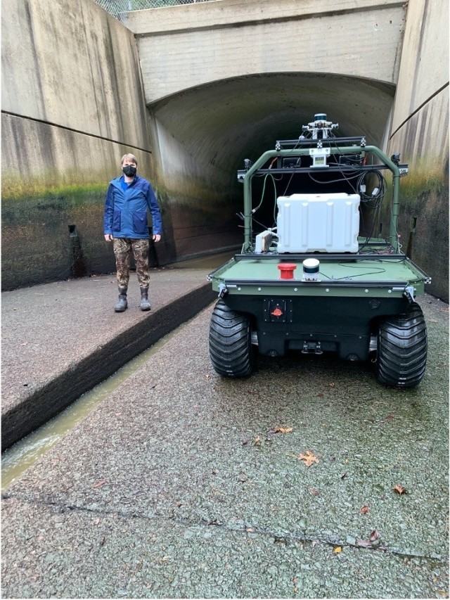 Principal Investigator Dr. Anton Netchaev stands next to a robotic system known as Dambot near the entrance of the outlet works at Blue Mountain Dam, Arkansas, in October 2020. Dambot takes the human element out of a dangerous but necessary U.S....