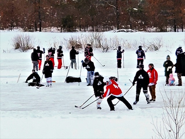 Teams compete in hockey action Feb. 13, 2021, during the Fort McCoy Pond Hockey Tournament on Big Sandy Lake on South Post at Fort McCoy, Wis. The tournament included eight teams from the post and local communities. There were also $1,280 in...