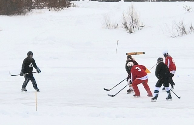 Teams compete in hockey action Feb. 13, 2021, during the Fort McCoy Pond Hockey Tournament on Big Sandy Lake on South Post at Fort McCoy, Wis. The tournament included eight teams from the post and local communities. There were also $1,280 in...