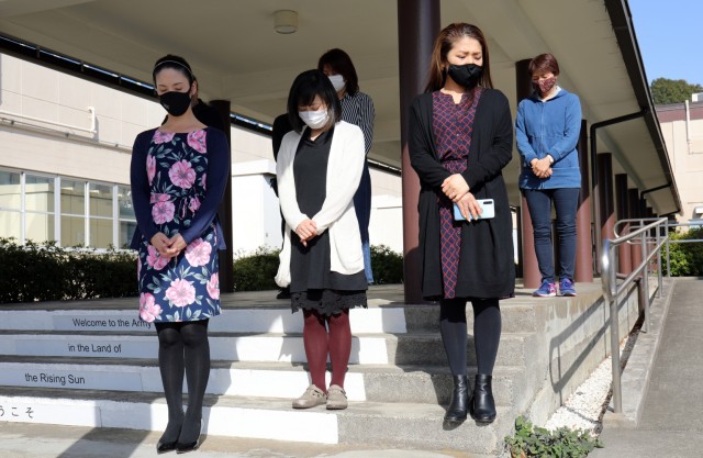 U.S. Army Garrison Japan employees stand outside the headquarters building at Camp Zama, Japan, at 2:46 p.m. March 11, in commemoration of the magnitude 9.0 earthquake that struck off the eastern coast of Japan 10 years ago.