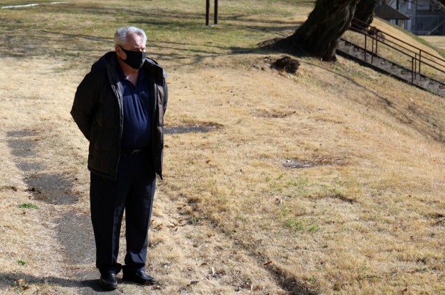 Scot Freeman, emergency management officer, U.S. Army Garrison Japan, stands outside the headquarters building at Camp Zama, Japan, at 2:46 p.m. March 11, in commemoration of the magnitude 9.0 earthquake that struck off the eastern coast of Japan...